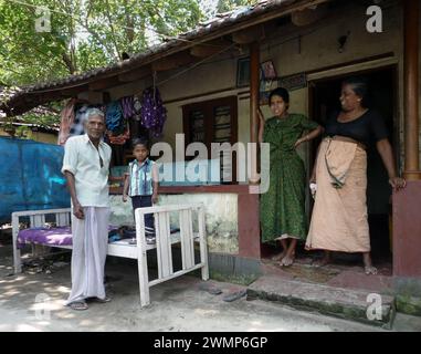 India, Kerala, Cochin: an Indian family on the doorstep of their home Stock Photo