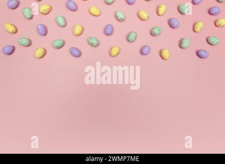 Top view of colourful easter eggs on pink background. Creative easter composition, spring, copy space, flat lay. Stock Photo