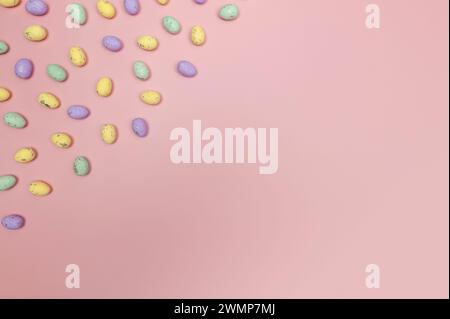Top view of colourful easter eggs on pink background. Creative easter composition, spring, copy space, flat lay. Stock Photo