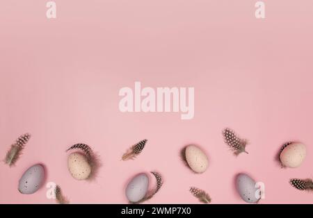 Top view of easter eggs, feathers on pink background. Creative easter composition, spring, flat lay, copy space. Stock Photo