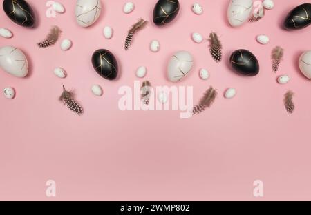 Top view of easter eggs, feathers on pink background. Creative easter composition, spring, flat lay, copy space. Stock Photo