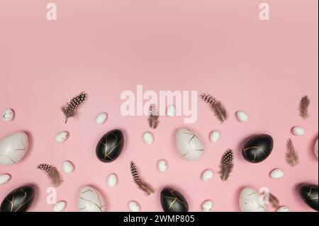Top view of easter eggs, feathers on pink background. Creative easter composition, spring, flat lay, copy space. Stock Photo
