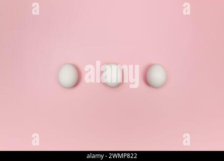 Top view of three white eggs on pink background. Creative easter composition, flat lay, copy space. Spring, modern and minimalist. Stock Photo