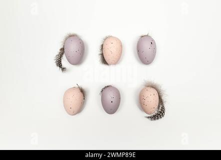 Top view of six colourful easter eggs on white background. Creative easter composition, spring, copy space, flat lay. Stock Photo