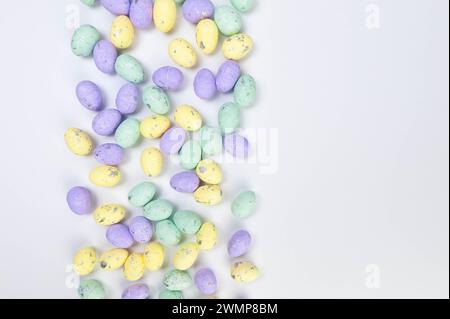 Top view of colourful easter eggs on white background. Creative easter composition, spring, copy space, flat lay. Stock Photo