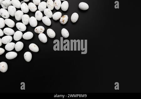 Top view of white easter eggs on black background. Creative easter composition, spring, copy space, flat lay. Stock Photo