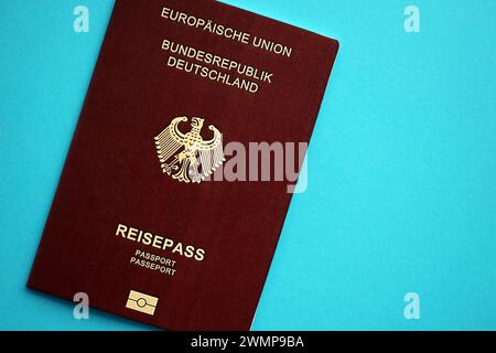 Red German passport of European Union on blue background close up. Tourism and citizenship concept Stock Photo