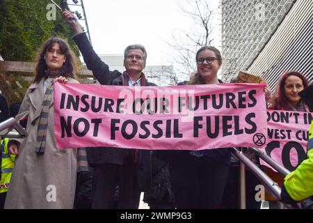 London, UK. 27th February 2024. Activists who occupied Tokio Marine offices leave the premises. Extinction Rebellion activists marched and occupied insurance companies’ offices in the City of London, the capital’s financial district, calling on the companies to stop insuring fossil fuel projects. Credit: Vuk Valcic/Alamy Live News Stock Photo