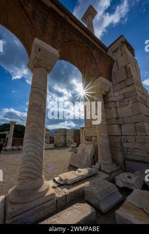 The ruins of ancient Ephesus with grand columns under clear blue sky ...