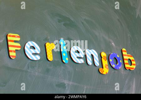 Symbol image of a holiday job: (School) board with the german inscription FERIENJOB Stock Photo