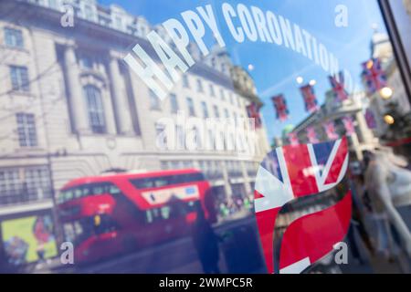 Union flags are reflected in shop window decorations on Regent Street as London prepares for the coronation of King Charles III. Stock Photo