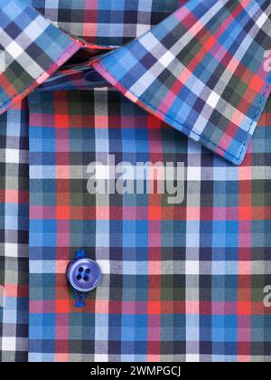 Close-up of a button placket on a multi-colored plaid men's shirt Stock Photo