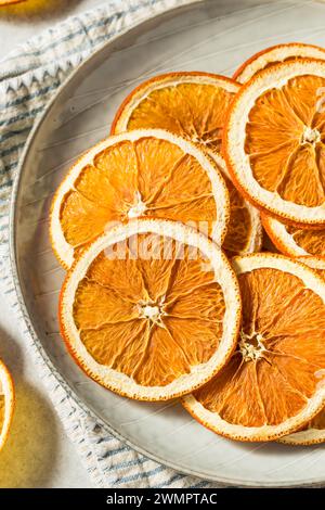 Healthy Organic Dried Dehydrated Orange Slices in a Bowl Stock Photo