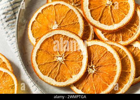 Healthy Organic Dried Dehydrated Orange Slices in a Bowl Stock Photo
