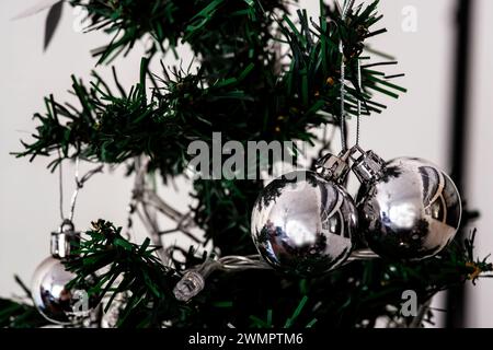 A cluster of gleaming decorations on a Christmas tree branch, with room for text on the opposite side Stock Photo