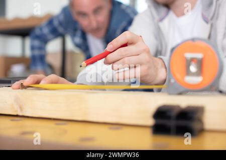 cropped view od supervisor watching apprentice mark wood Stock Photo