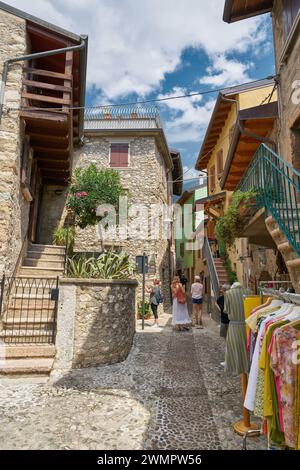 Narrow alley with small stores in the picturesque old town of Malcesine on Lake Garda in Italy Stock Photo