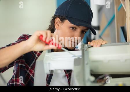 a woman fixing a printer Stock Photo