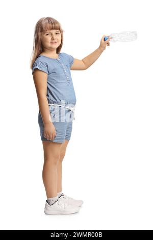 Child holding an empty plastic bottle isolated on white background Stock Photo