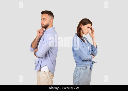 Upset european couple turned away, contemplative poses Stock Photo