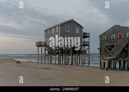 Houses crumble into the sea in Outer Banks due to some of the most rapid rates of coastal erosion and sea level rise on the East Coast, USA. Stock Photo