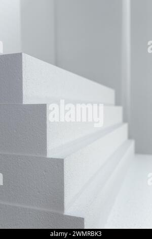 Close up of large panels of Styrofoam are stacked in a warehouse ...