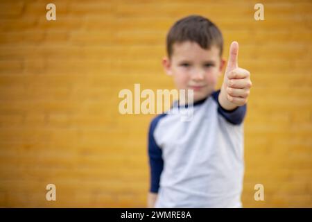 Boy Giving Thumbs Up to Camera Stock Photo