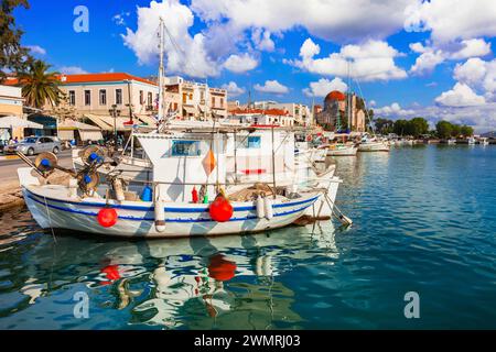Saronics islands of Greece . Charming beautiful Greek island -Aegina with traditional fishing boats and St. Nicholas Church Stock Photo