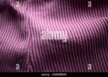 Close-up of purple knit with seam, ribbed, distinct texture, curved fabric. Stock Photo