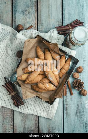 Freshly baked croissants on wooden background Warm Fresh Buttery Croissants and Rolls. homemade baking. Bagels. Cosiness. Stock Photo