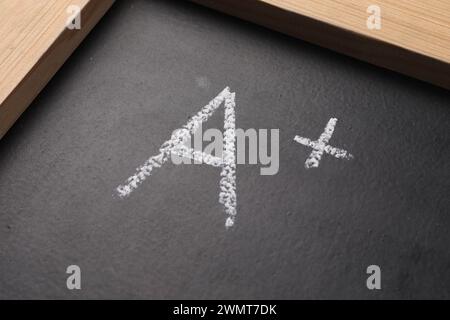 School grade. Letter A with plus symbol on blackboard, closeup Stock Photo