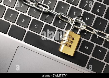 Cyber security. Padlock with chain on laptop, top view Stock Photo