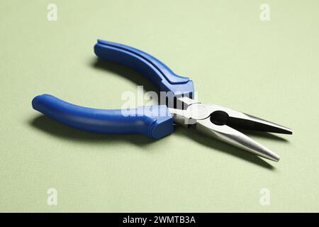 Needle nose pliers on olive background, closeup Stock Photo