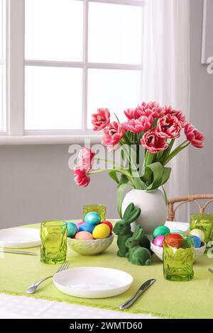 Beautiful table serving with red tulips for Easter celebration Stock Photo