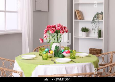 Beautiful table serving for Easter celebration in light dining room Stock Photo