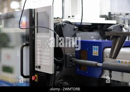 Automatic plastic injection molding press machine close up. Selective focus. Stock Photo