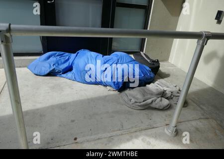 Santa Monica, California, USA 25th February 2024 Homeless person on sidewalk on February 25, 2024 in Santa Monica, California, USA. Photo by Barry King/Alamy Stock Photo Stock Photo