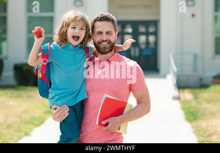 Teachers day. School boy going to school with father. Father leads a little child school boy in first grade. Stock Photo