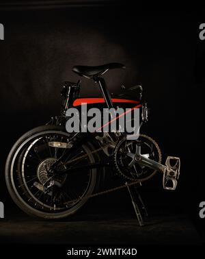 Folding bicycle isolated on dark or black Stock Photo