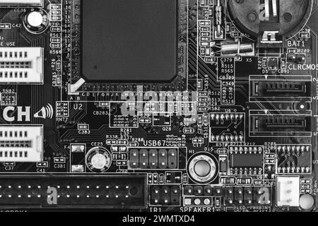 closeup of circuit board with resistors, condensers, microchips and electronic components. b/w. Stock Photo