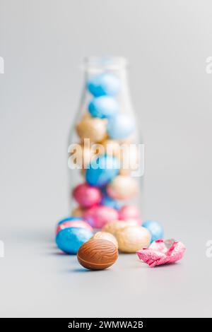 Easter chocolate eggs wrapped in aluminium foil on the gray background. Stock Photo