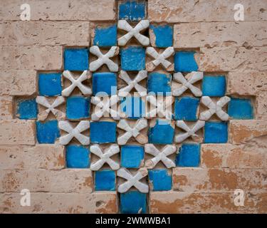 Ancient blue tile geometric decor pattern on brick wall at shrine of Jalaluddin Surkh Posh Bukhari in Uch Sharif, Bahawalpur, Punjab, Pakistan Stock Photo