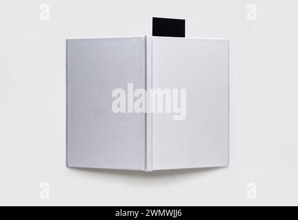 A blank book with a black bookmark on a white background Stock Photo