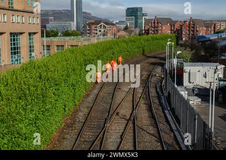 Belfast County Antrim Northern Ireland February 23 2024 - Railway  workers walking on the railway tracks in Belfast checking line for faults Stock Photo