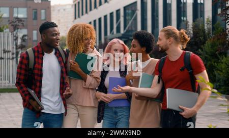 University friendship funny speaking emotional joyful diverse people teens high school pupils happy multiracial friends classmates multiethnic Stock Photo
