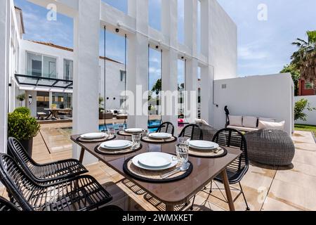 an image of outdoor dining table set up with plates and ready for a meal in the garden Stock Photo