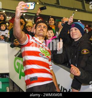 Nathan Cleary takes selfie wearing Wigan shirt with Warriors fans after Penrith defeat in World Club Challenge Stock Photo