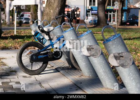 Children bicycle next to Nextbike stands, empty racks during winter Stock Photo