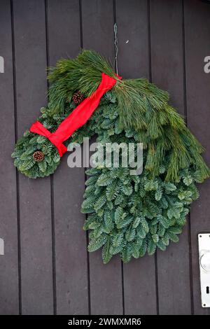Horse head made from conifer twigs as a door wreath. Germany Stock Photo