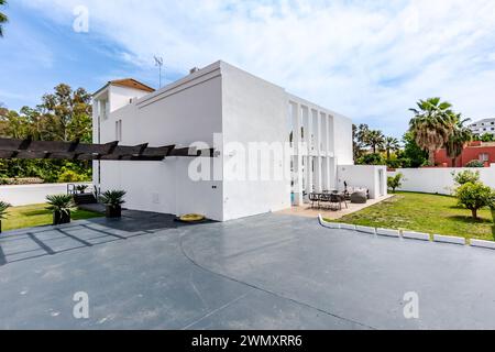 the private parking area for multiple vehicles behind a luxury mediterranean villa Stock Photo